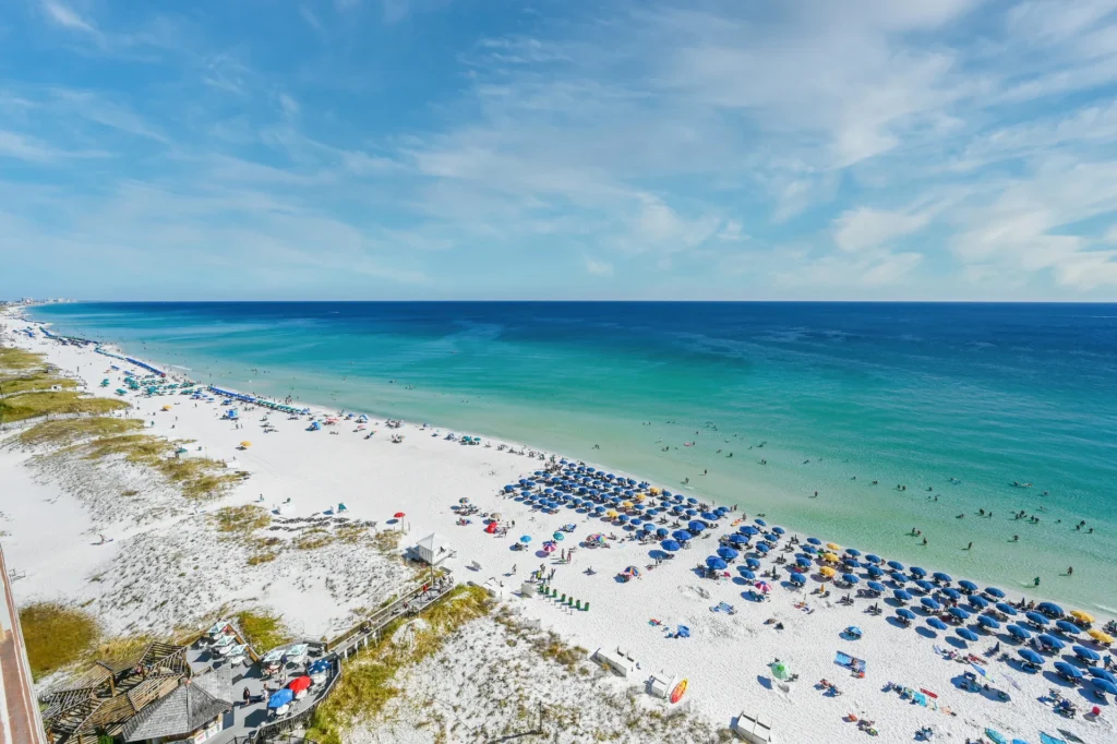 Aerial view of Destin's white-sand beach and emerald Gulf water at Pelican Beach Resort